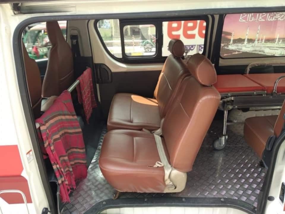 Inside an AC ambulance in Dhaka: stretcher and seats for family
