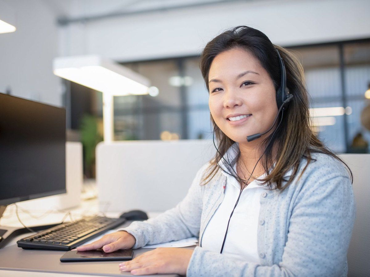 A dispatcher with a headset taking an ambulance call