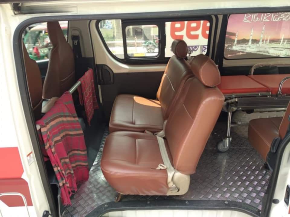 Interior view of Ambulance Service Gulshan with patient stretcher and passenger seats.
